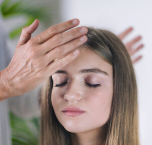 Healing hands on 3rd-eye chakra for what is Reiki attunement
