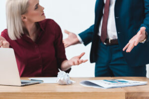 Annoyed female and male employees for overstepping boundaries at work