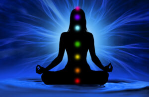 Woman with glowing chakras for what happens when you balance your chakras