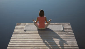 Woman on the edge of a dock for find that right meditation practice for you