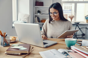 Happy woman at computer for fulfilling work