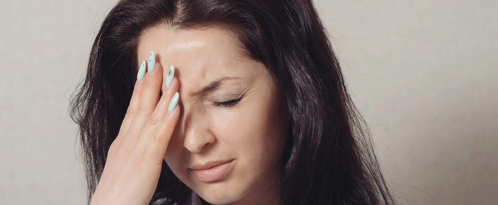 Woman expressing pain or anguish who needs and energy clearing