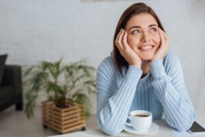 Smiling thinking woman for the power of positive self talk and postive thinking
