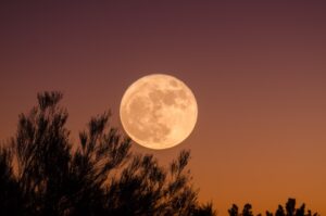 Full moon on orange sky for moon energy | the meaning of moon phases